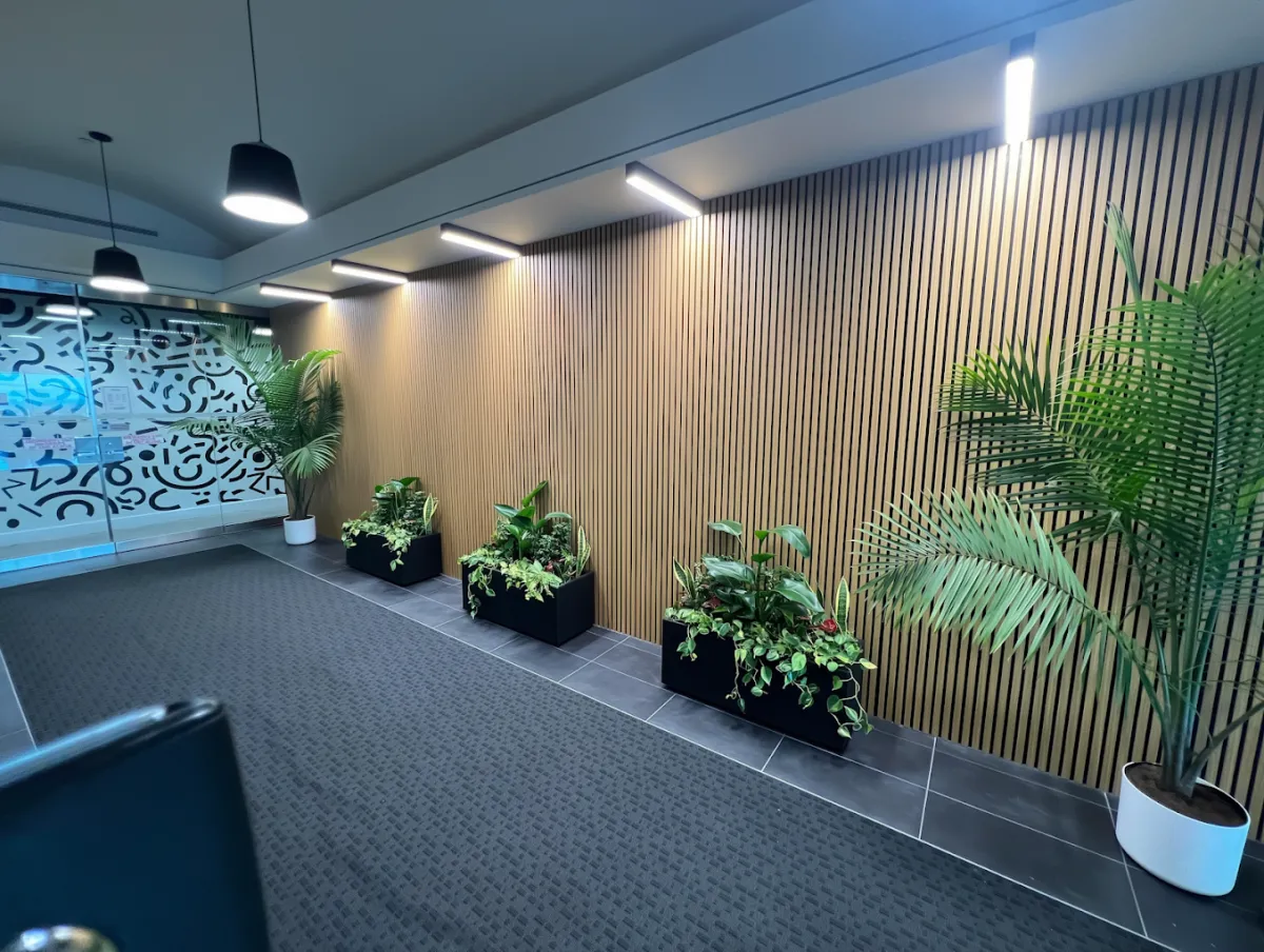Entrance hallway to the Graceway Wellness suite with wood slat walls and plants