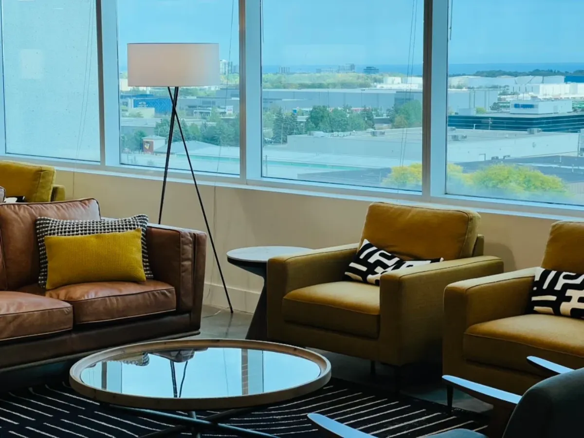 Bright waiting lounge at the Burlington office with armchairs and large windows